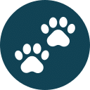 White paw prints icon on a dark teal circular background.